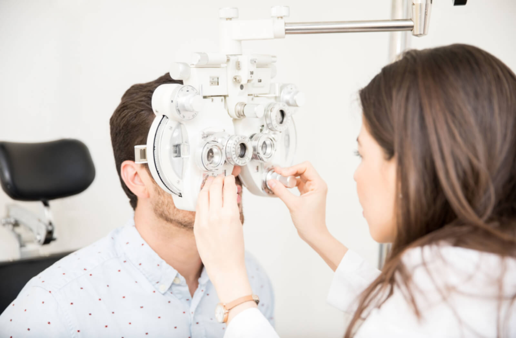 Optometrist conducting an eye exam on her patient to assess his eye health and suitability for contact lenses.