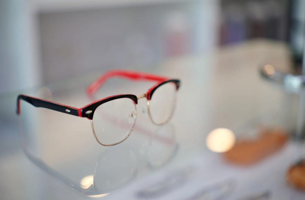 A pair of eyeglasses with progressive lenses on a display rack.