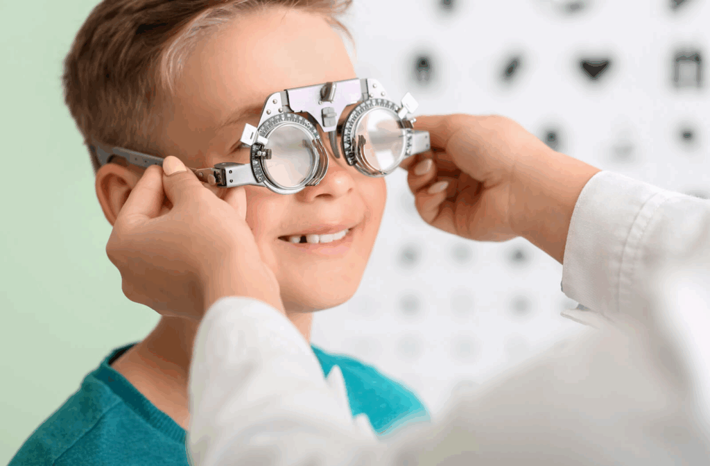 A young child at an eye exam being tested for refractive errors.