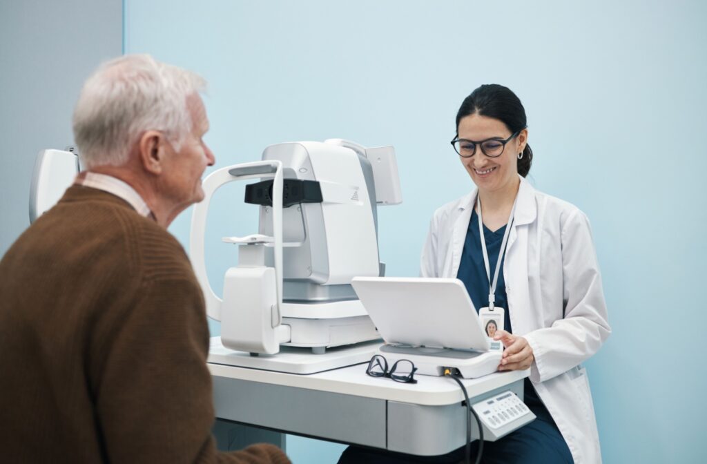 An eye doctor and patient during a regular eye exam to monitor for signs of eye problems that can arise without noticeable symptoms.